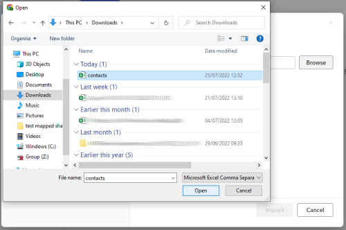 Screenshot showing the contacts.csv file selected in Downloads folder